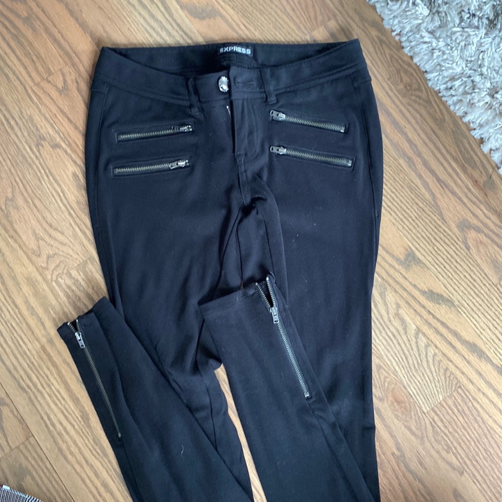 Express stretch pants with zipper detail.